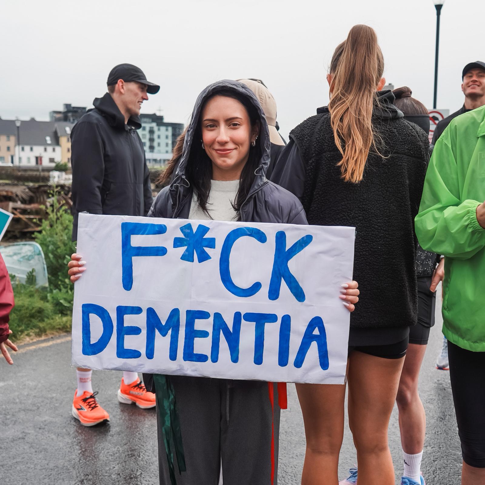 A supporter at the finish line with a hand-painted sign